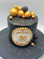 Black and Golden Cake with golden spheres and elegant black buttercream design